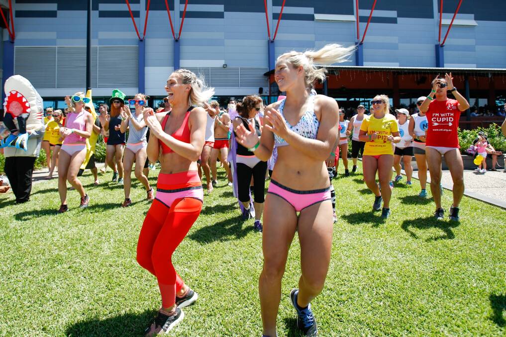 CHEEKY: Sportswomen Emma Tonegato and Allana Ferguson warming-up before Wollongong’s inaugural Cupid’s Undie Run for the Children’s Tumour Foundation.