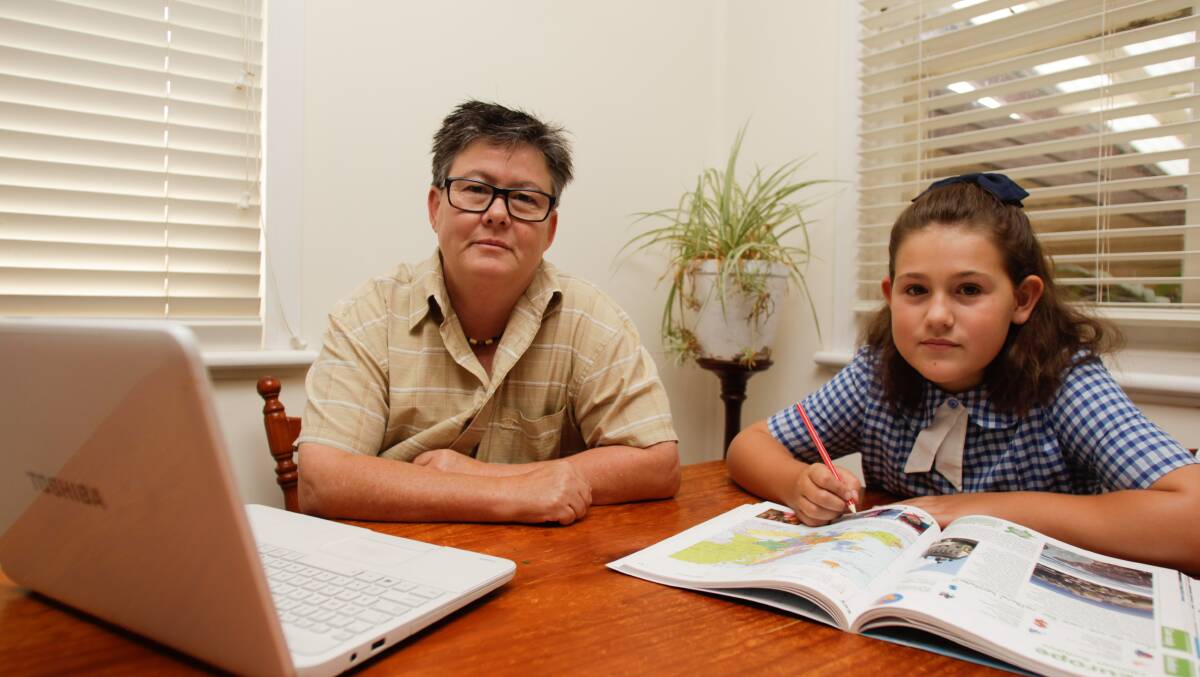 Towradgi resident Cate McFarlane - with daughter Edie - says her internet connection has been terrible since she switched to the NBN three months ago. Picture: Georgia Matts