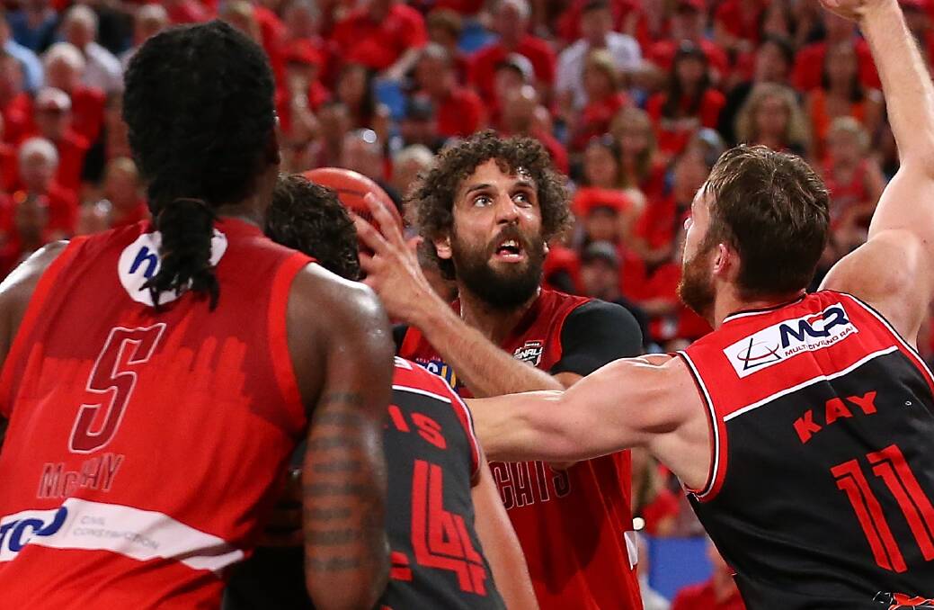 TOUGH AND GO: Wildcats big-man Matt Knight (centre, red) is rated a 50-50 chance to play in game three against the Illawarra Hawks. Picture: GETTY IMAGES