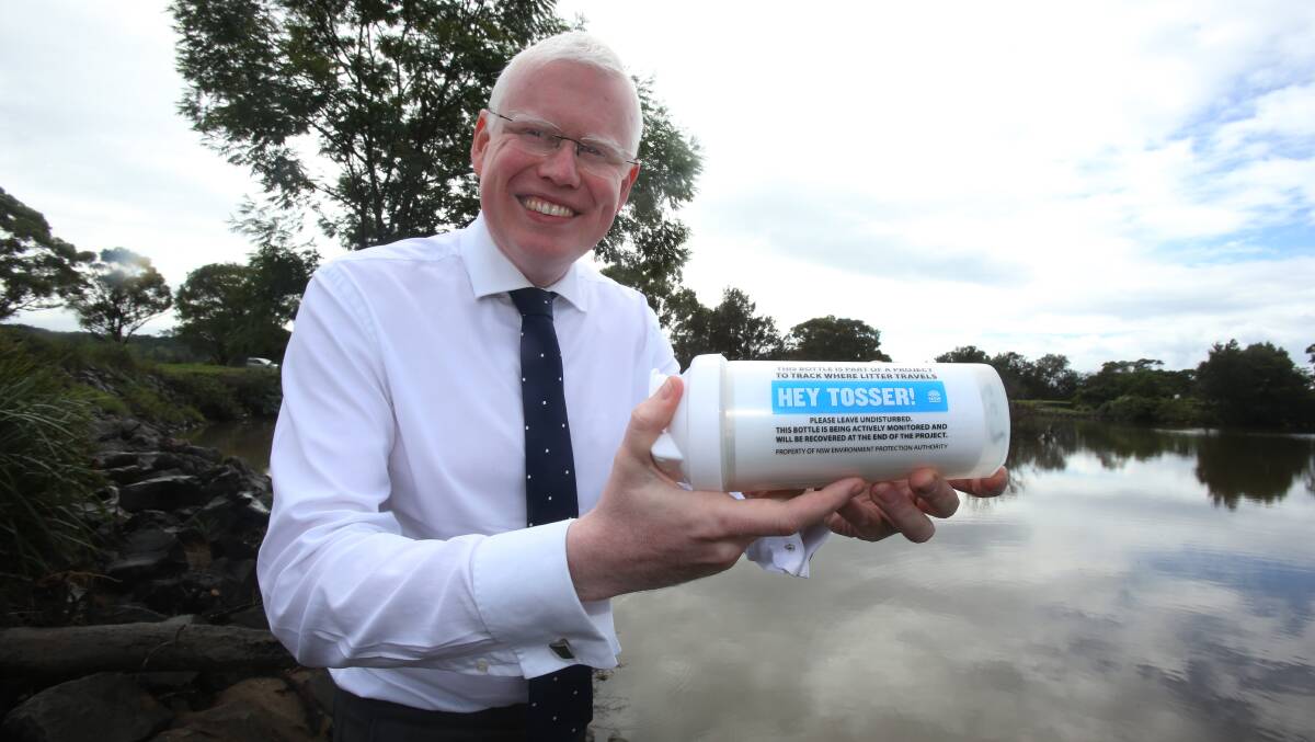 Gareth Ward with the bottle fitted with GPS he threw into Mullet Creek. The GPS will alllow its path to be tracked through the Illawarra's waterways. Picture: Robert Peet