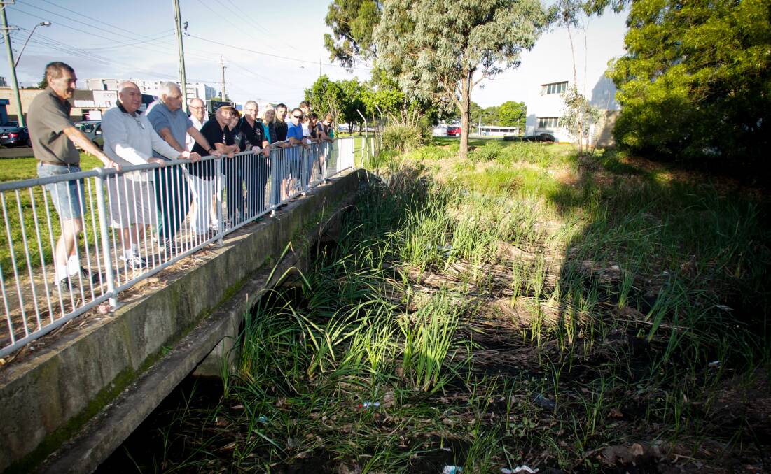 DO SOMETHING: Wollongong residents gathered at the Swan St bridge in 2017 calling for action to reduce flooding.