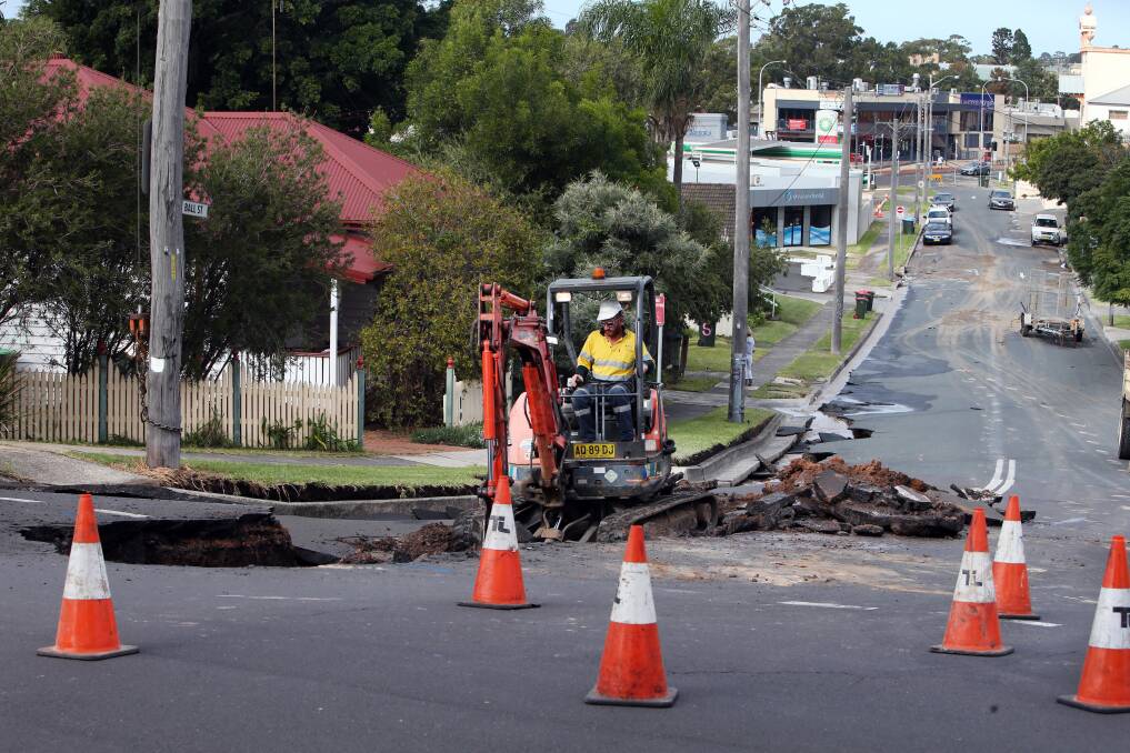 A burst water main in Woonona causes a section of the road to collapse and leaves more than 100 homes without water for most of the day. Picture: Sylvia Liber