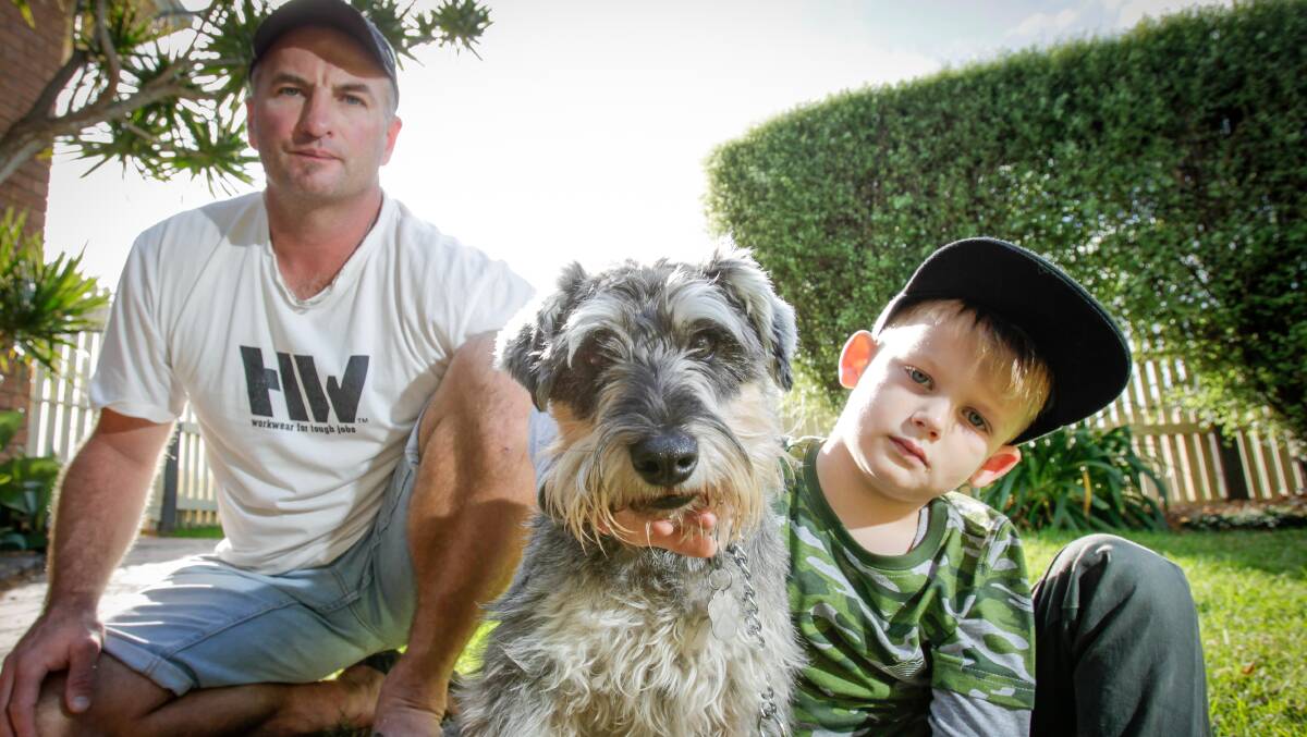 Without warning: Figtree resident Jason Tagliapietra, pictured with his four-year-old son Beau, copped a fine despite having what he believed were valid registration papers for pet schnauzer Chewy. Picture: Adam McLean