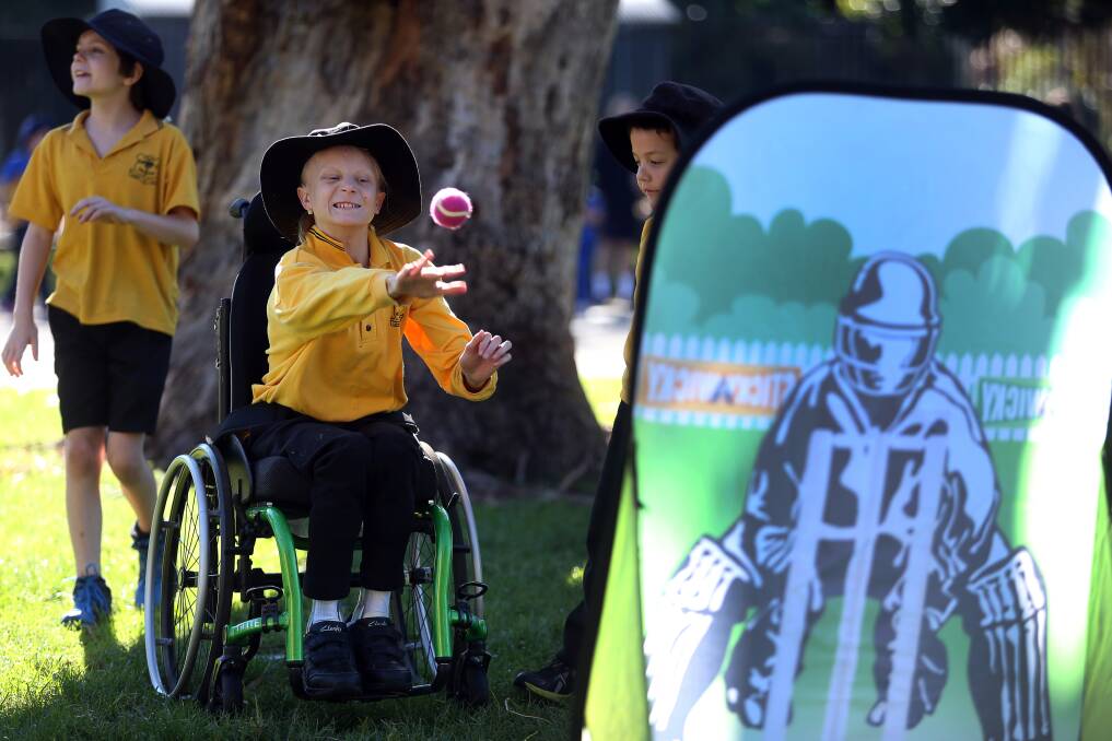 HOWZAT: Fairy Meadow Demonstration School student Olivia Healy enjoying the 'stcky wicky' activity during the DreamCricket clinic for children with a disability. Picture: Robert Peet