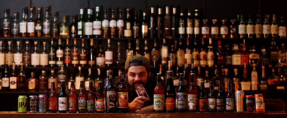 Howlin' Wolf co-owner Ben Abraham with just a sample of the 70-odd different beers on offer at the bar. He reckons that could be a beer record for bars in the Illawarra. Picture: Robert Peet