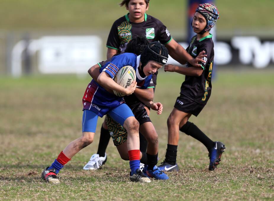 Caught: Gerringong's Wyland Hall takes the ball up against Nowra East in the Paul McGregor Shield final.  Pictures: Robert Peet