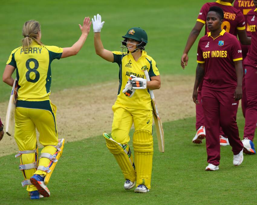 High five: Century=maker Nicole Bolton (right) and  Ellyse Perry celebrate victory against the West Indies  in England. Picture: Stu Forster/Getty Images