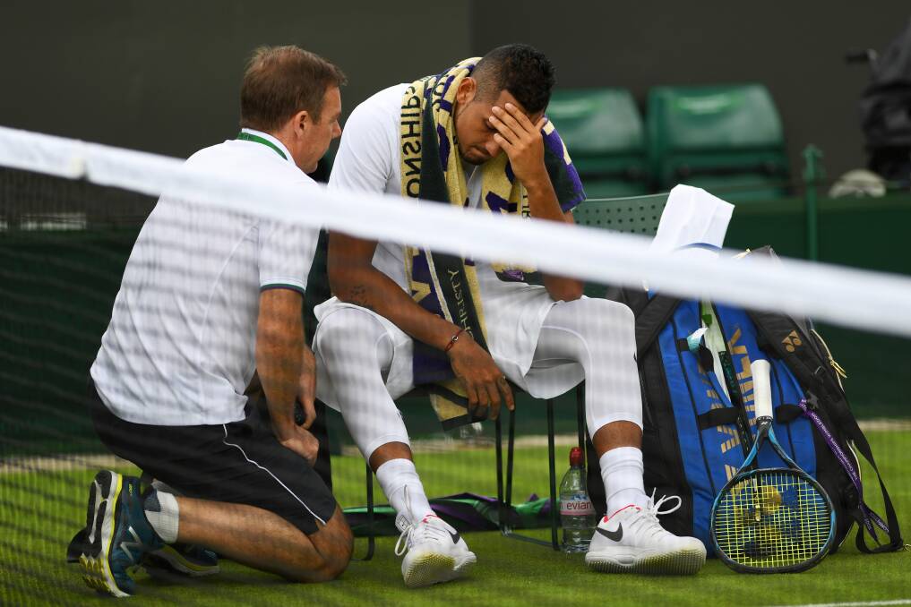 Feel the pain: An injured Nick Kyrgios of Australia reacts as he retires during the first round match against Pierre-Hugues Herbert. Picture: Shaun Botterill/Getty Images