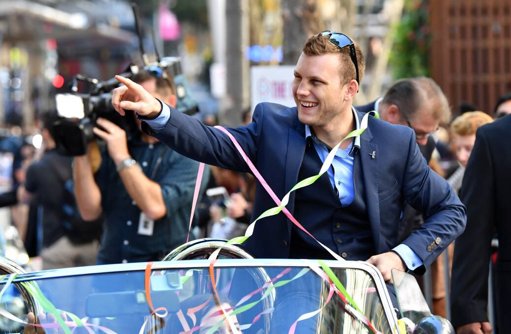 Pack a punch: WBO World welterweight champion Jeff Horn is honoured in a ticker tape parade in Brisbane. Picture: AAP Image/Darren England