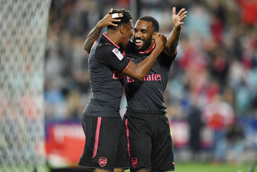 STAR POWER: Arsenal's Alexandre Lacazette (right) celebrates with Alex Iwobi. Picture: AAP