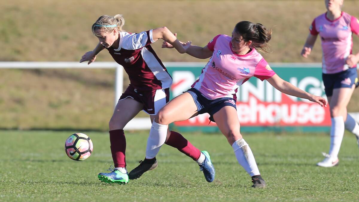 UP FOR THE FIGHT: Stingrays forward Emma Rolston battles for possession during Illawarra's win over Macathur Rams. Picture: Robert Peet