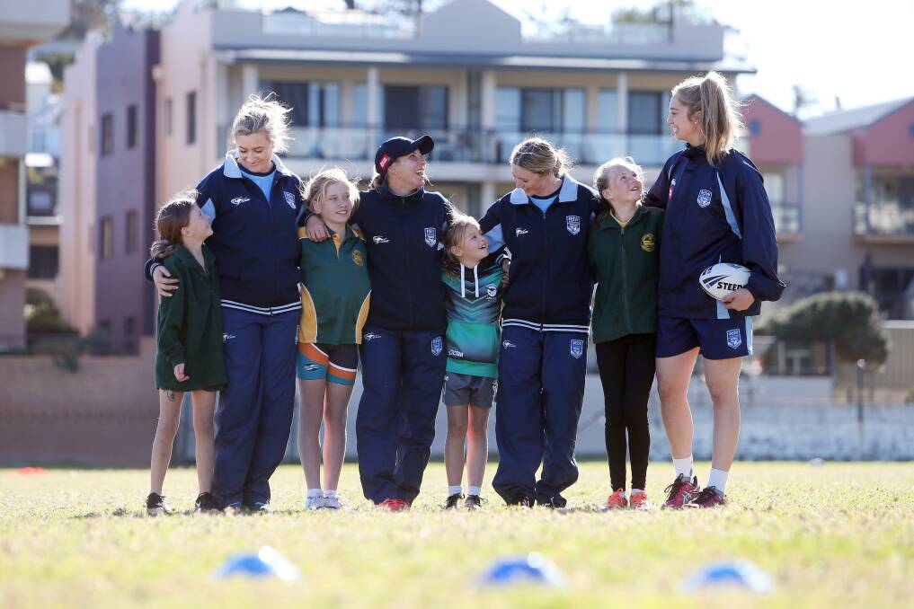 LOOKING UP: Minnamurra Primary School students Ivy Rogers, Tara Rumbel,Addison Corcoran and Ava Snelling meet NSW stars Ruan Sims, Sam Bremner, Maddie Studdon and Kezie Apps. Picture: Sylvia Liber