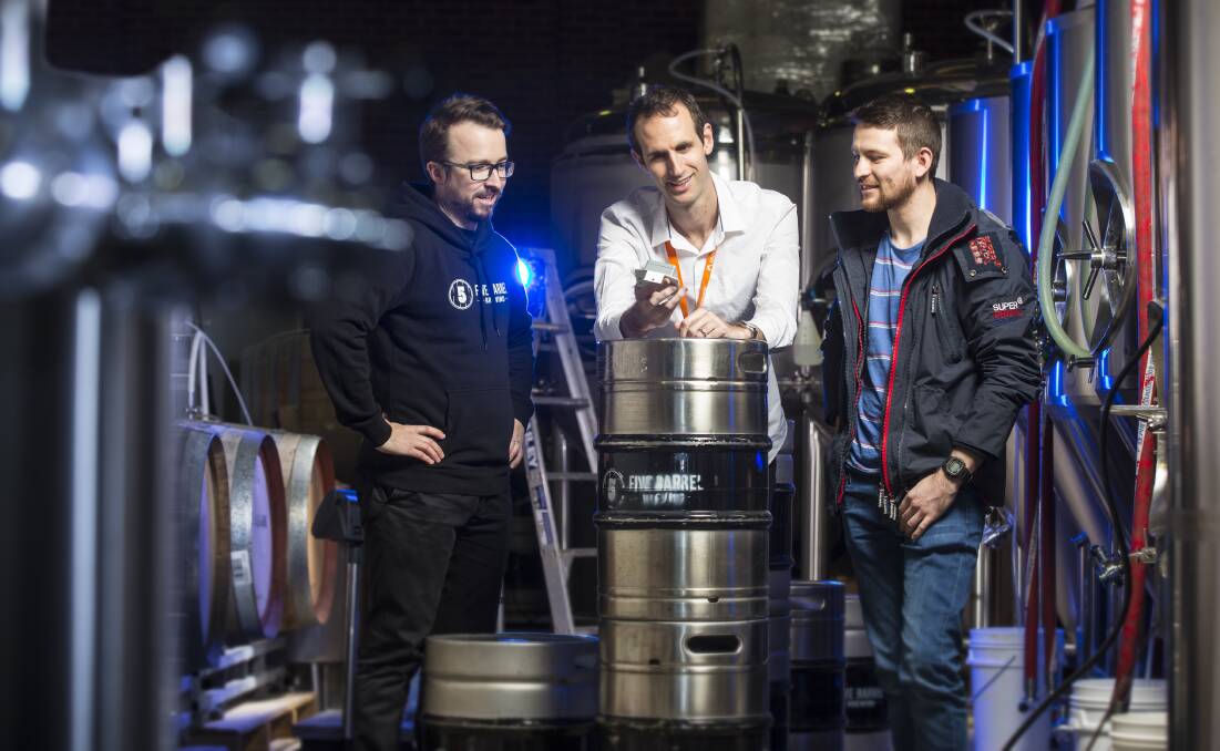 Michael Burton (centre) is developing a sensor that will tell bars and breweries when a keg is almost empty.  