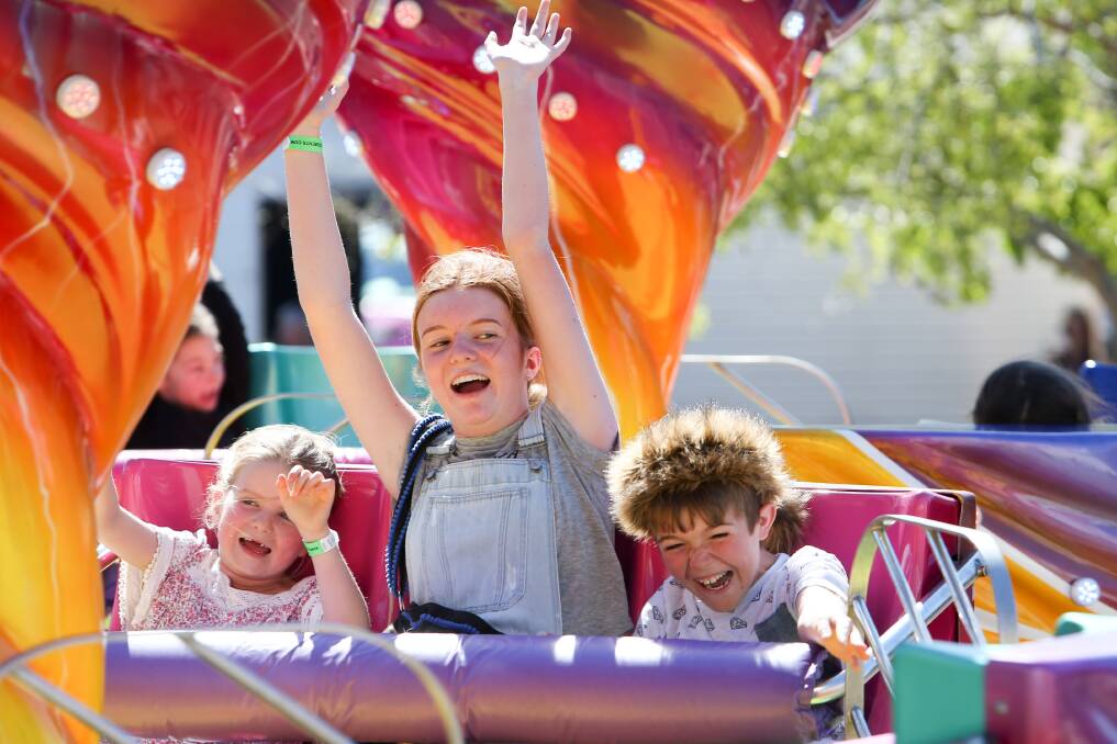 Maggie Healey, Lily Healey and Tyler Hampton enjoying an amusement ride at Dapto Street Fair in 2017. Picture: Adam McLean