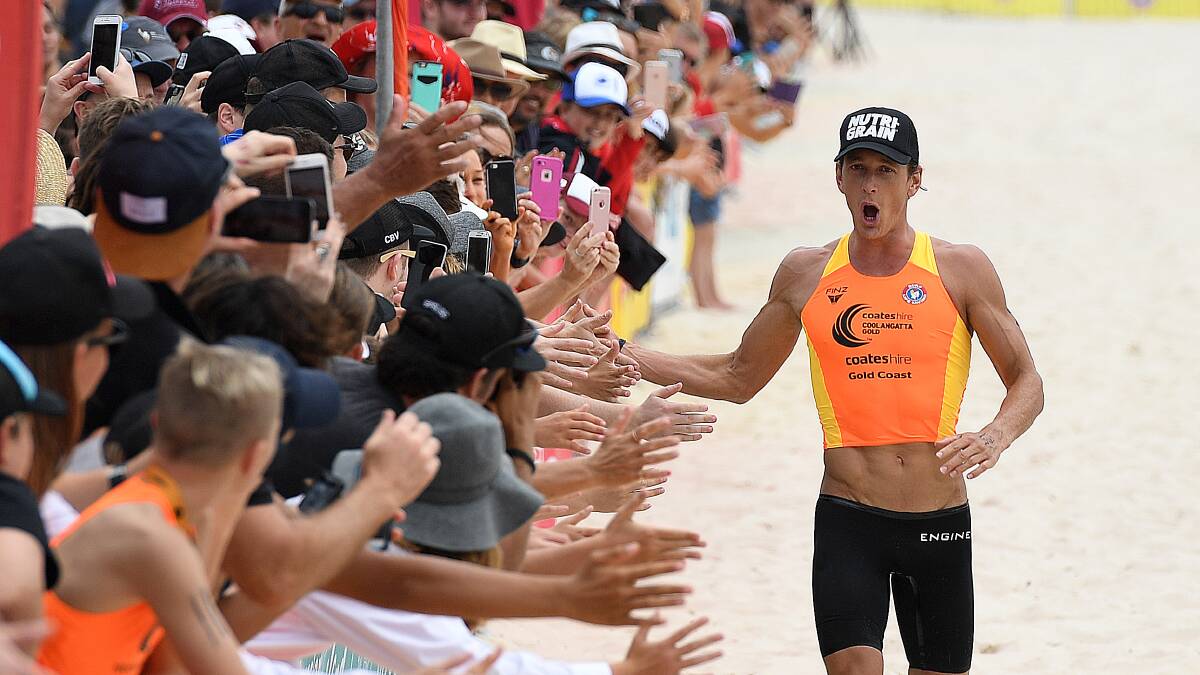 Ali Day reacts with spectators as he wins the Coolangatta Gold iron man race at Coolangatta Beach, Coolangatta, Sunday, October 8, 2017.  (AAP Image/Dave Hunt) NO ARCHIVING