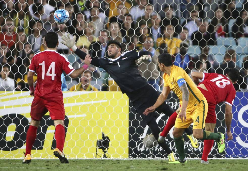 Find the net: Tim Cahill scores the winner against Syria. Picture: AP Photo/Rick Rycroft