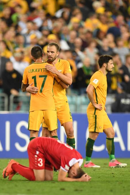 ONE TO GO: Australia's Nikita Rukavytsya and Matthew Jurman celebrate their win over Syria in October. Picture: AAP