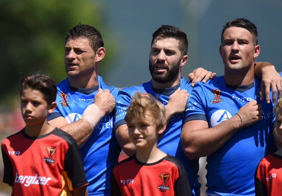 Hit: James Tedesco (centre) during the Italian national anthem. Picture: NRL Imagery