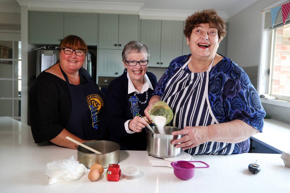 STIRRING THE POT: Penny Melville-Brown from Hampshire in the UK is learning cooking secrets of the CWA with Johanne Holt and Jennifer Bowe in Kiama. Picture: Sylvia Liber