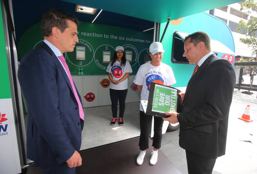 On file: Illawarra Labor MPs Ryan Park and Paul Scully hand a file of information on the Gong Shuttle to Transport for NSW workers. Picture: Robert Peet