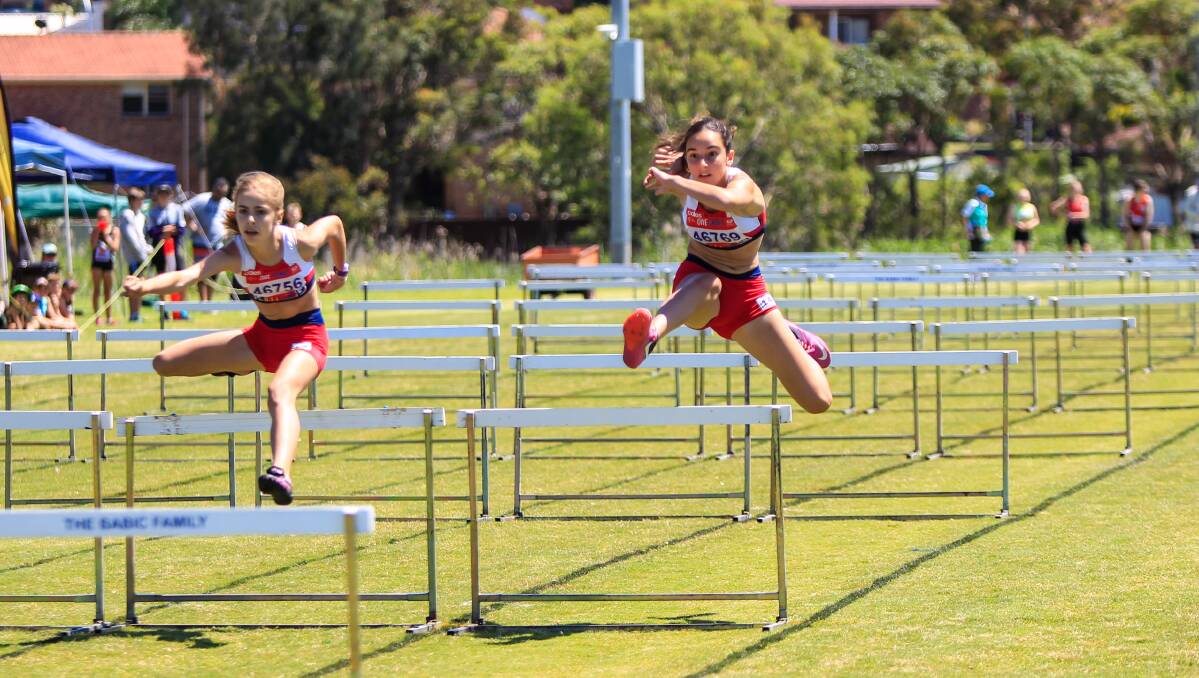 Leap: Albion Park's Abby Cox and Jayda Amidzovski competing South Coast zone Little hurdles event at Flinders. 