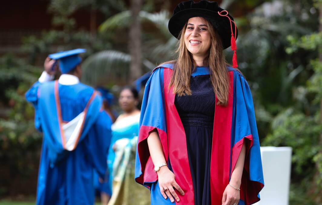 HAPPY STUDENT: Mona Nikidehaghani graduated from the University of Wollongong on Friday with a Doctorate in Accounting. She moved from Iran to Australia in 2012.  Picture: Adam McLean