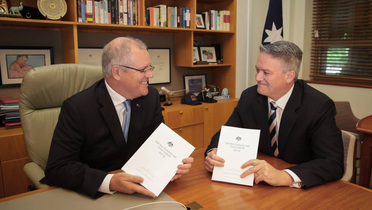 Treasurer Scott Morrison and Minister for Finance Mathias Cormann pose for photos with the Mid Year Economic and Fiscal Outlook (MYEFO) 2017-18). Picture: Alex Ellinghausen