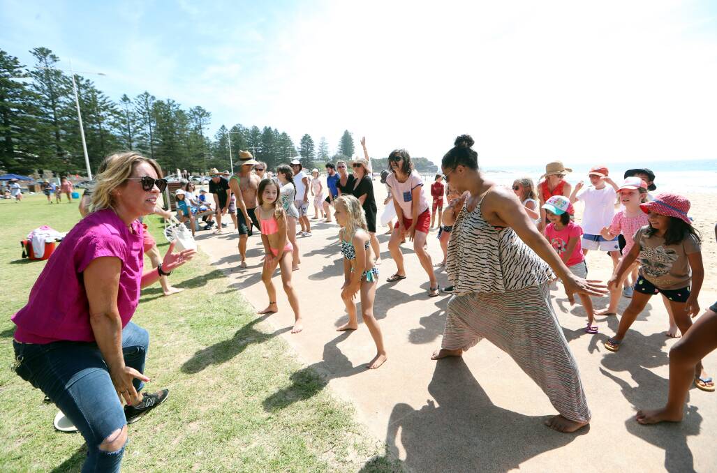 FINAL TOUCHES: Emma Saunders going through one of the last rehearsals with some of the flash mob participants on Friday at Austinmer Beach. Picture: Sylvia Liber
