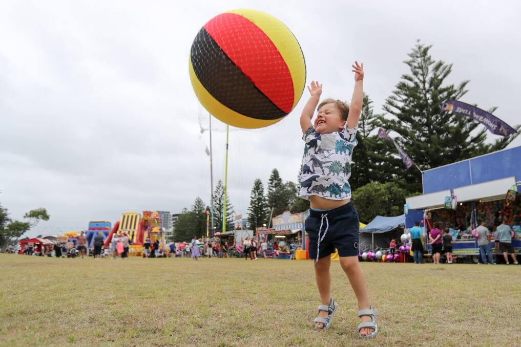 Up, up and away: Three-year-old Vincent Denino plays with his sideshow prize at Lang Park during Sunday's New Year's Eve festivities. Photo: Adam McLean