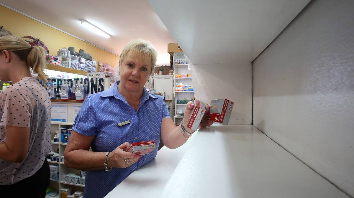 Empty shelves: Navin Pharmacy assistant Margaret Loughrey with the last packets of products containing codeine still available for over-the-counter sales on Tuesday. They will be prescription only from Thursday. Picture: Robert Peet