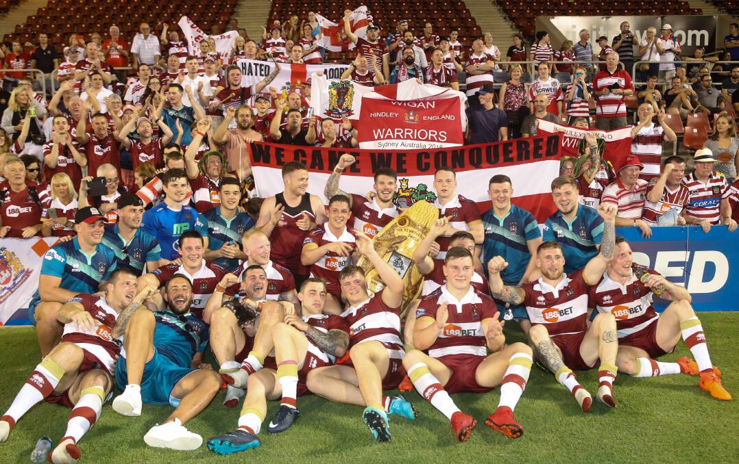 Summer success: Wigan players and fans celebrate beating Hull in a Super League game played at WIN Stadium in February. Wigan meet Warrington in the grand final on Sunday (AEST). Picture: Adam McLean