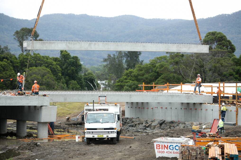 Workers building the Fowlers Road bridge at West Dapto ... Wollongong City Council will vote on a name for the bridge at Monday night's meeting. Picture: Adam McLean