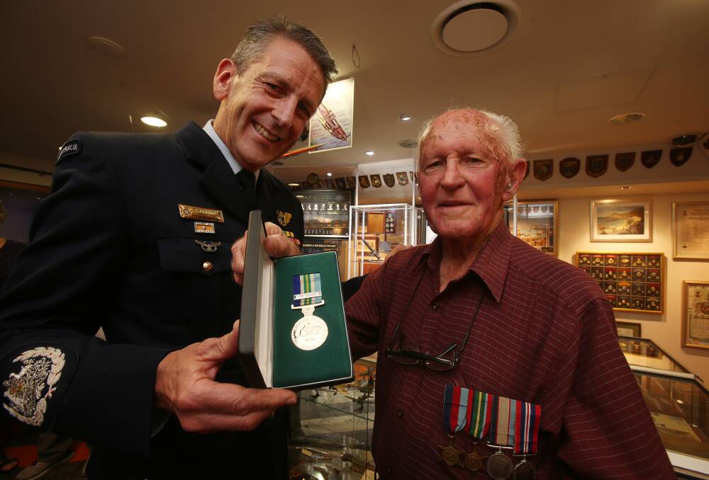 Warrant Officer Rob Swanwick with Illawarra resident George Burgess, 93, a RAAF war veteran. Picture: Robert Peet