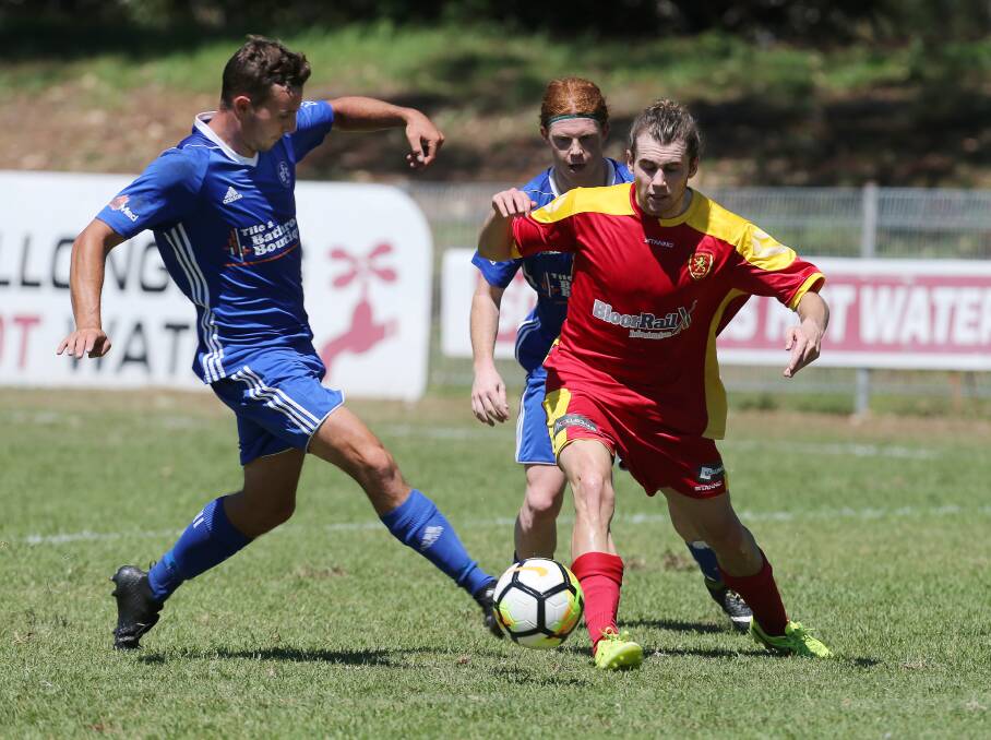 BIG MONTH: Wollongong United's Maty Brennan fights for possession against Bulli at Memorial Park. Picture: Robert Peet