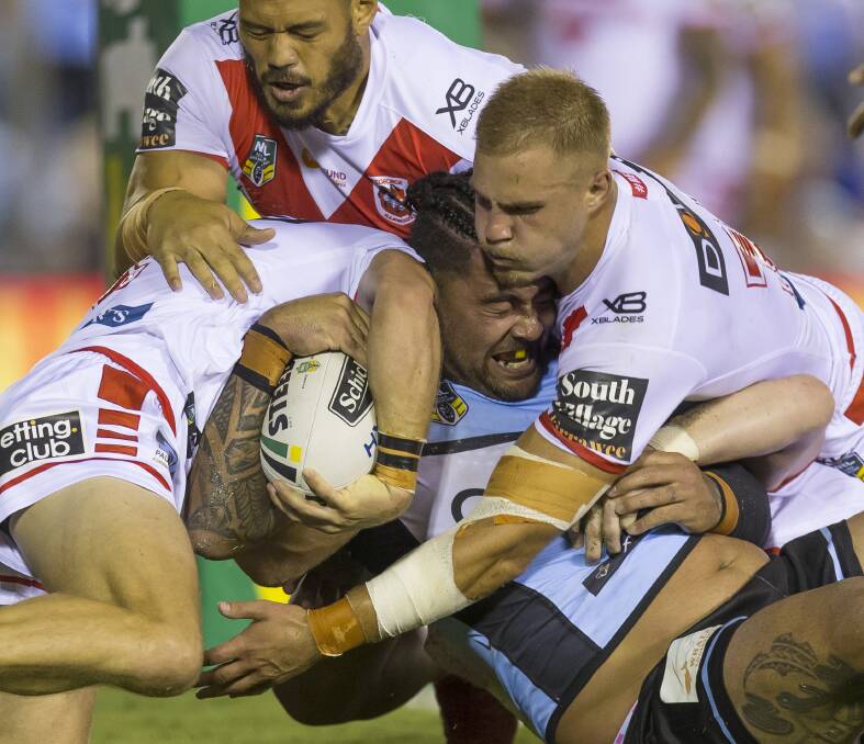 WAR: Andrew Fifita comes to grips with the Dragons defence in round two. Picture: AAP