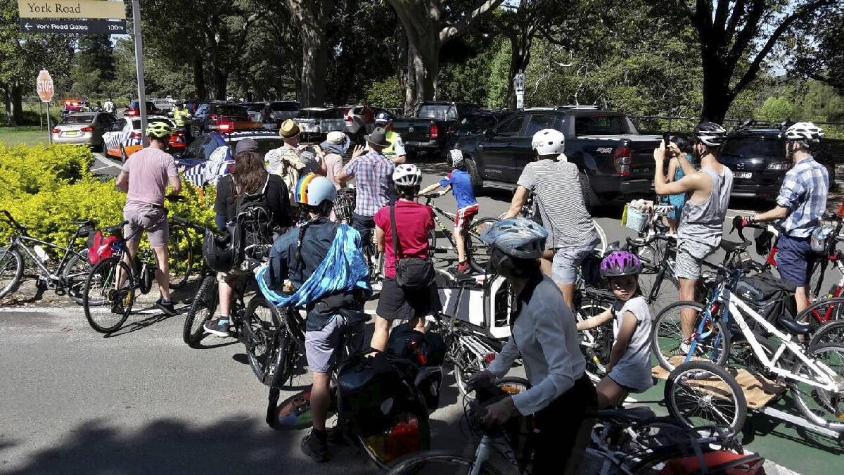 Steep: Police fining cyclists protesting against compulsory helmet laws in Sydney last year. The fine for not wearing a helmet now sits at $344.