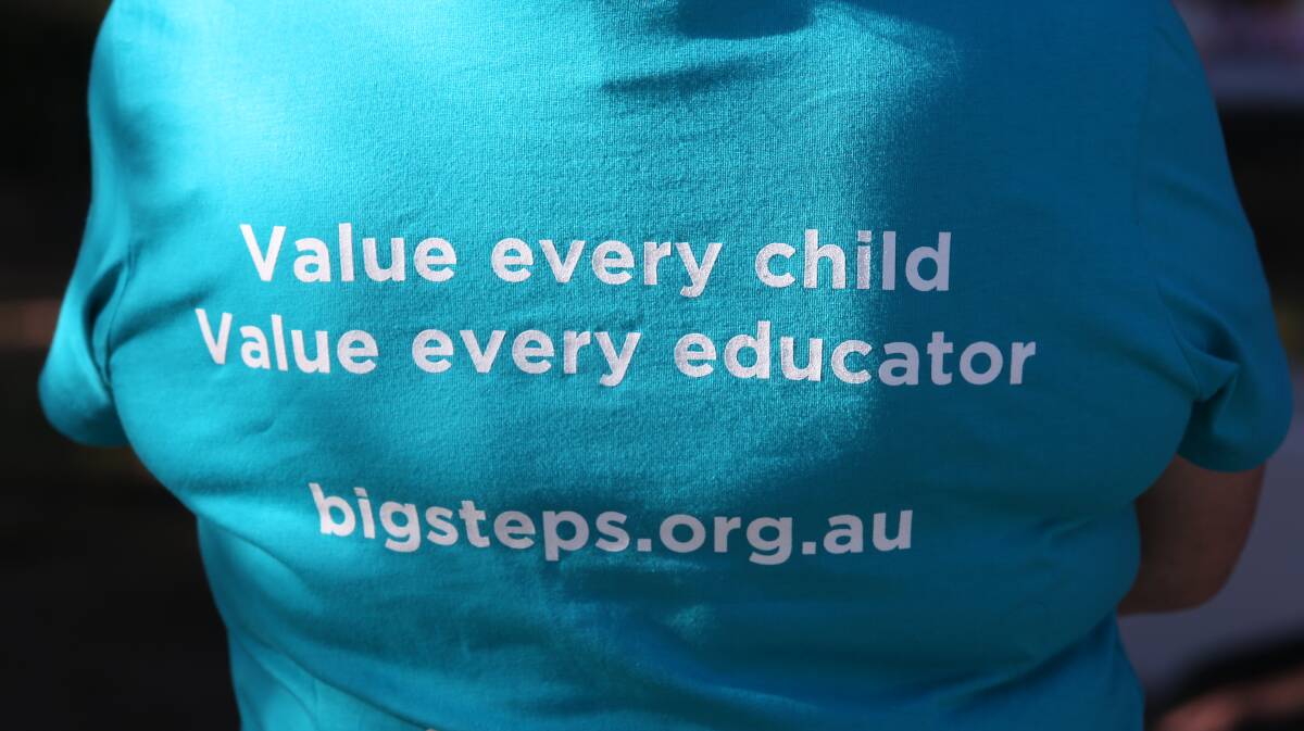 SIGN OF THE TIMES: Early childhood educators wore t-shirts to spell out what they want. Picture: Robert Peet
