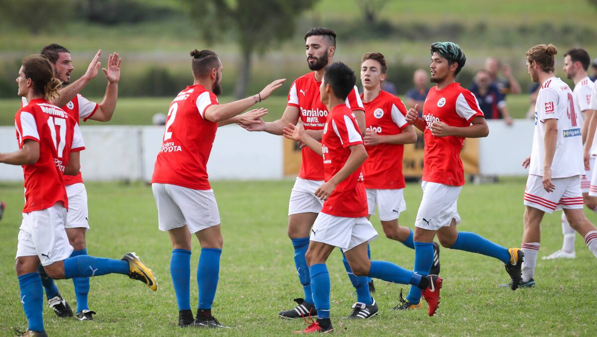 Fighting back: South Coast united players celebrating a goal against Albion Park White Eagles. Picture: Adam McLean