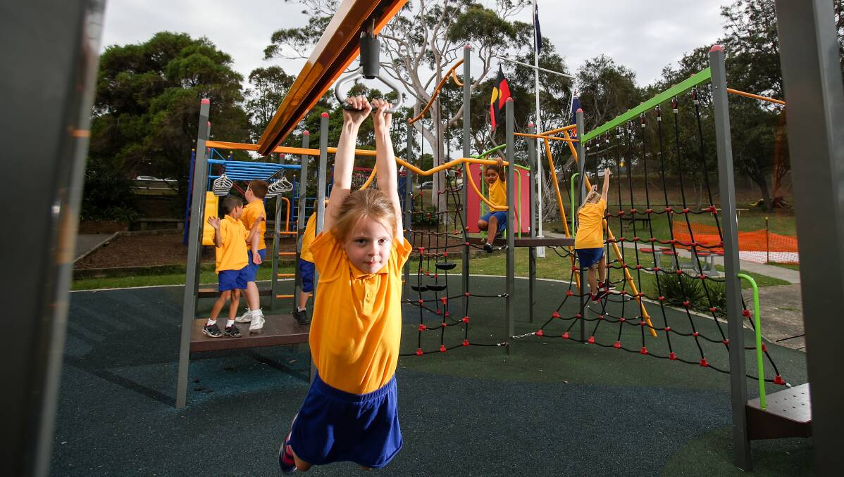 Public access: Lake Heights Public student Ella Vinkem at the playground, which will be open to all these school holidays. Picture: Adam McLean