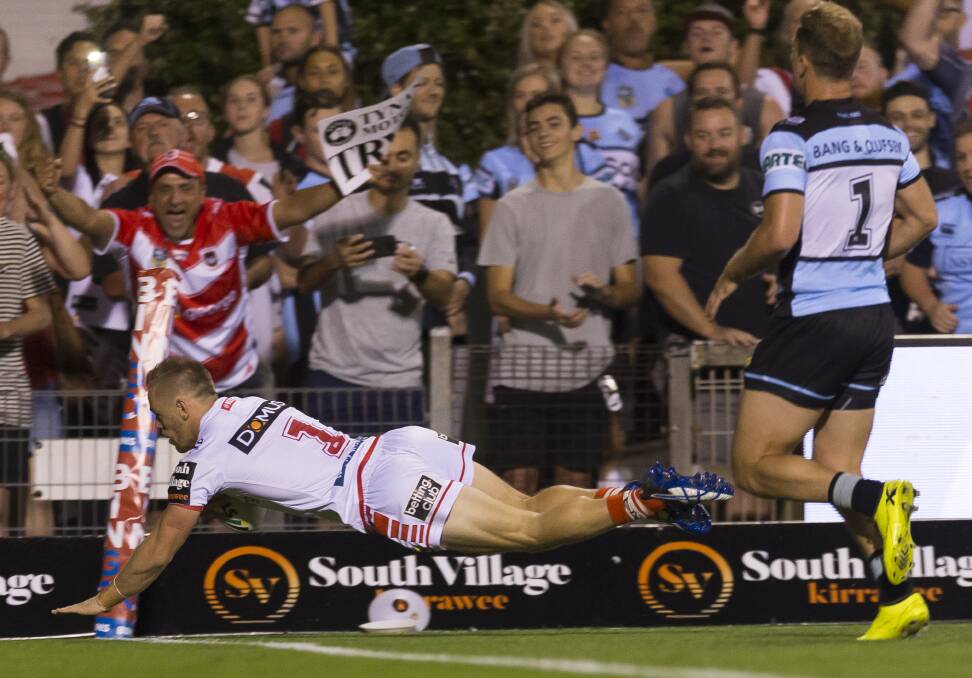DOUBLE: Matt Dufty crosses for the first of his two tries in the Dragons 40-20 win over Cronulla on Friday. Picture: AAP