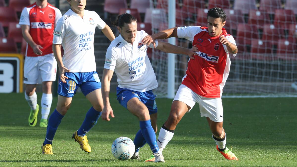 HARD FOUGHT: Wolves attacker Quivi Fowler battles for possession against the Bonnyrigg White Eagles at WIN Stadium. Picture: Georgia Matts