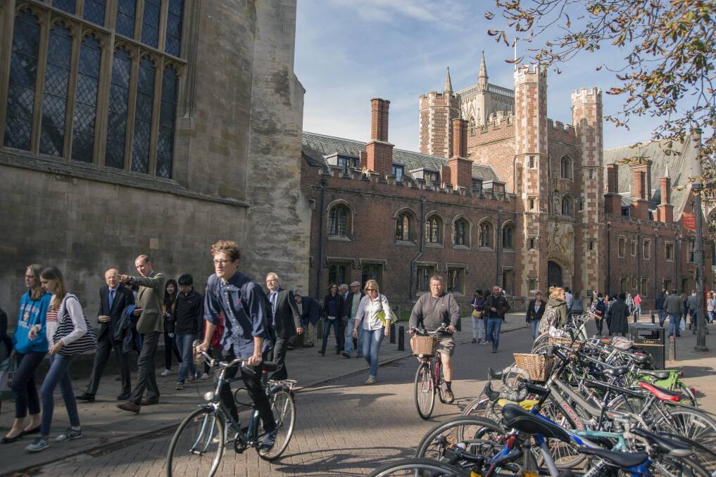 Cyclists and pedestrians move along Trinity Street past St Johns College, part of the University of Cambridge, U.K. Picture: Bloomberg