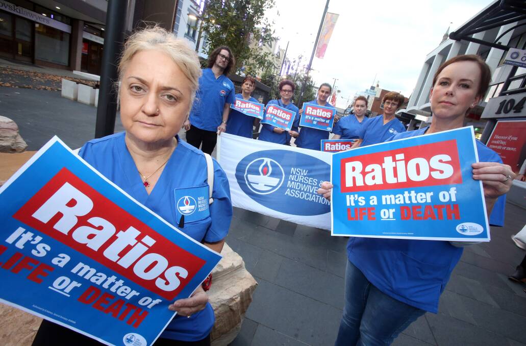 BOOST THE NUMBERS: NSW Nurses and Midwives Association members Julie Ljubovic and Chevonne Cowell with fellow members in Wollongong's Crown St Mall on Thursday night. Picture: Robert Peet.