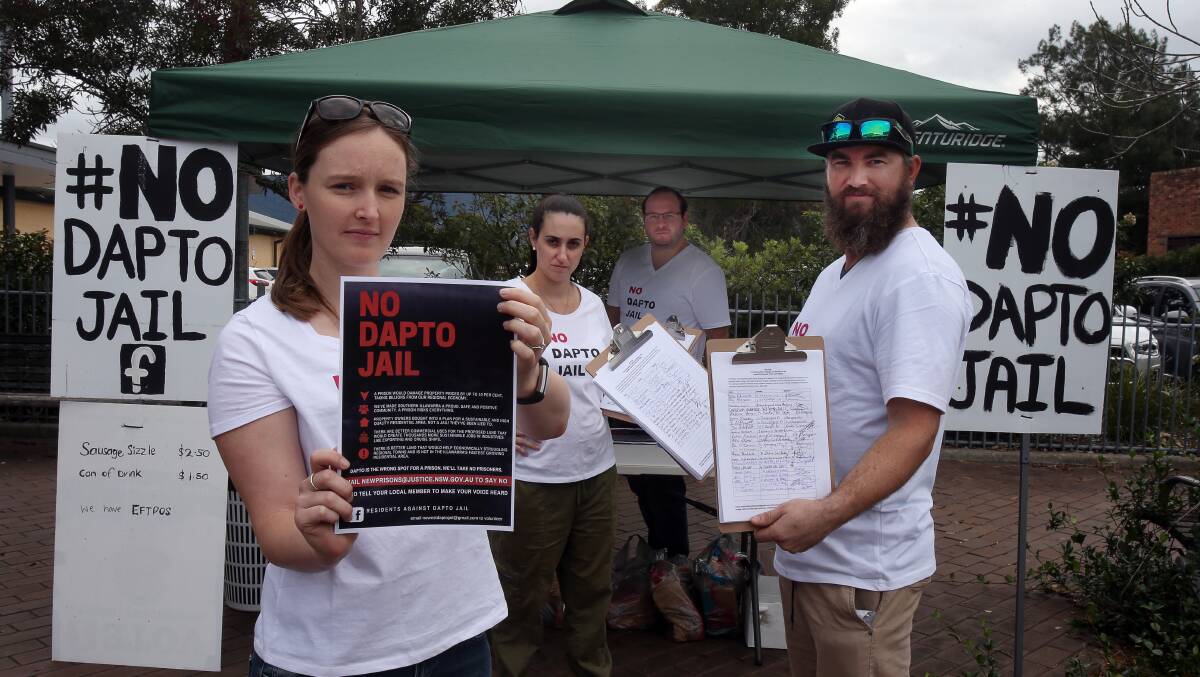 THE SIGN SAYS IT ALL: Residents Against Dapto Jail members Jess Meza, Ami Beck, Alen Meza and Stephen Beck launch their petition on the main street of Dapto on Sunday. Picture: Robert Peet