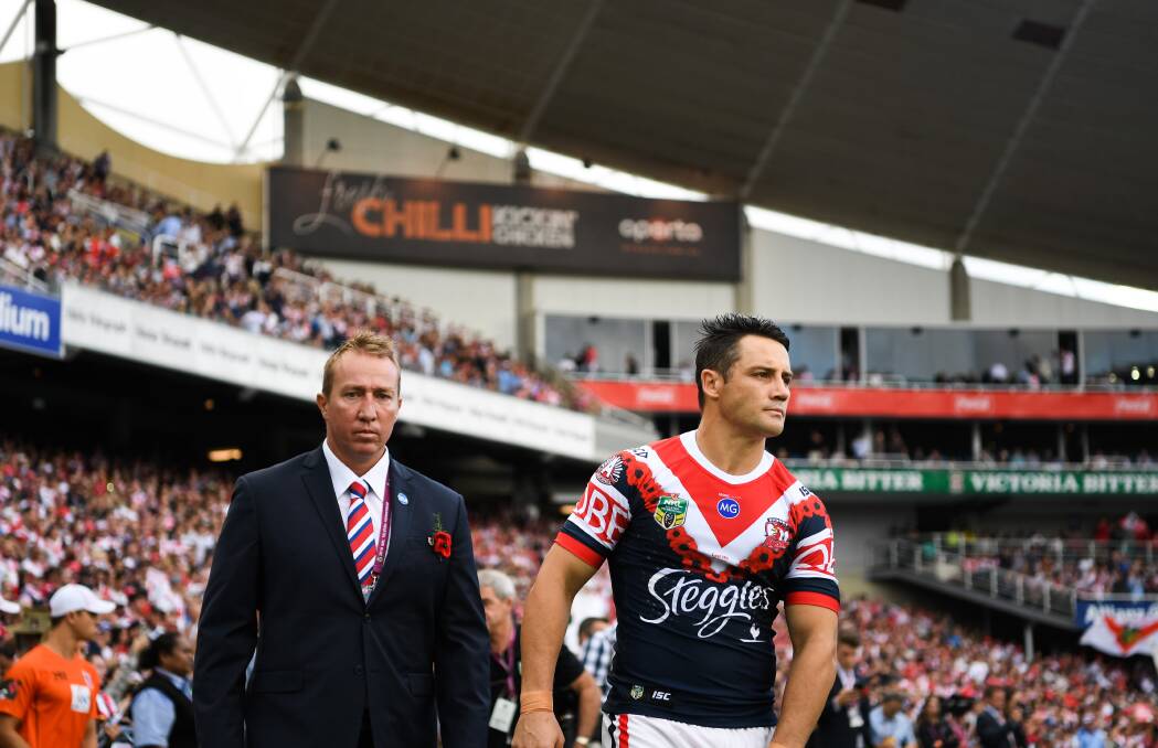 DEJECTED: Roosters coach Trent Robinson and Cooper Cronk leave the field after their defeat to the Dragons on Anzac Day last year. Picture: NRL Photos