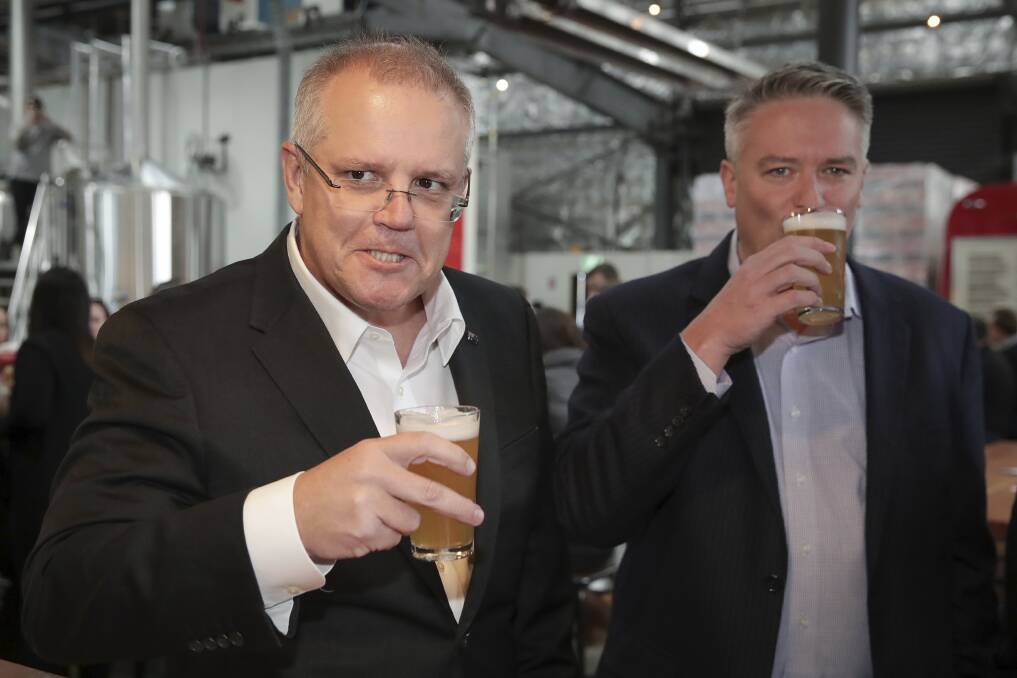 Treasurer Scott Morrison - with Minister for Finance Mathias Cormann  - at last week's announcement of tax cuts to help small brewers. It's just one example of politicians' habit of announcing what's in the budget before budget night. Picture: Alex Ellinghausen