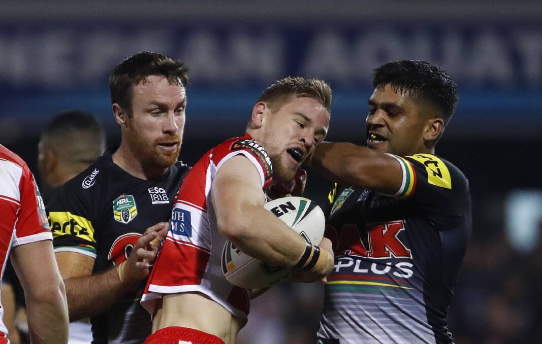 TOUGH NIGHT: James Maloney and Tyrone Peachey come to grips with Dragons fullback Matt Dufty on Saturday. Picture: AAP