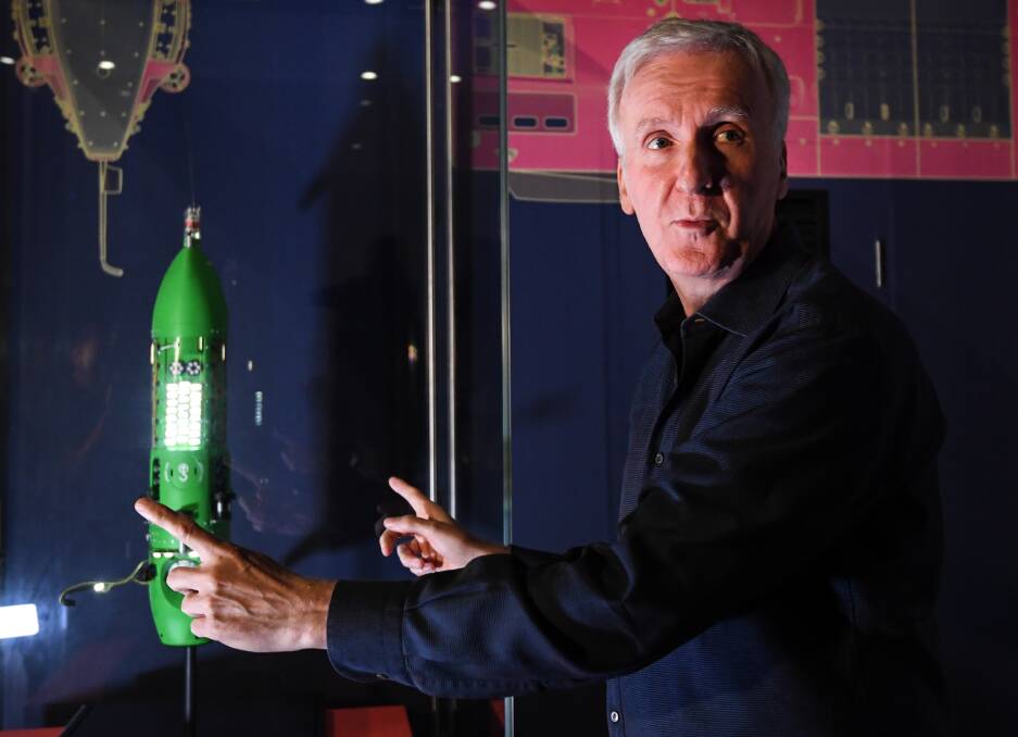 James Cameron with a scale model of the Deepsea Challenger submersible at the Challenging the Deep exhibition at the Australian National Maritime Museum in Sydney. The exhibition takes visitors to the ocean depths through the lens of deep-sea explorer and acclaimed film-maker James Cameron's underwater cameras. Picture: AAP/Peter Rae
