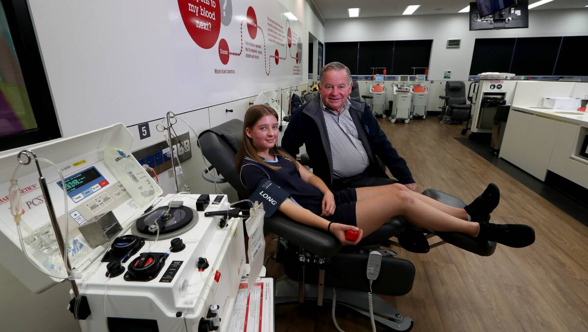 Saving lives: Corrimal resident Phillip Murray with his granddaughter Brittney Zulian, 18, who donated blood on his behalf on Wednesday. Picture: Sylvia Liber