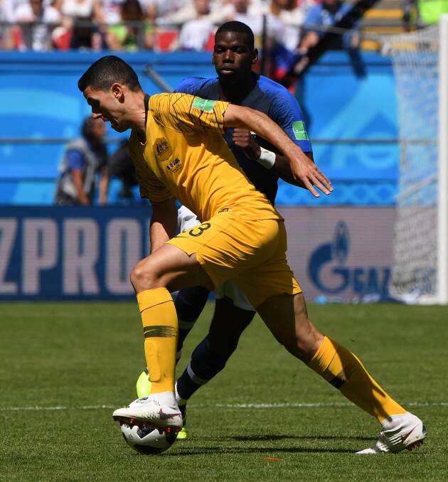 Tough contest: Tom Rogic fights for possession with France's Paul Pogba during Australia's opening World Cup clash. Picture: AAP Image/Dean Lewins.  